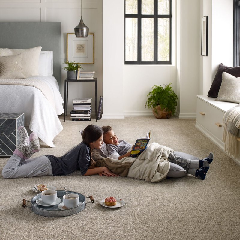 Two kids reading on bedroom carpet from Rugtex of Florida in Miami, FL
